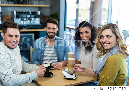 Smiling friends having a cup of coffee and cold coffee in cafÃƒÂ© 32101756