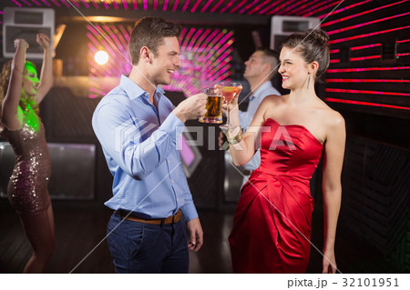 Smiling couple toasting glass of beer and cocktail 32101951