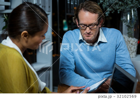 Business executives discussing over digital tablet Business executives discussing over digital tablet 32102569