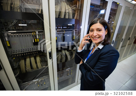 Technician talking on mobile phone Technician talking on mobile phone 32102588