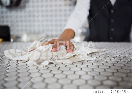 Waiter cleaning bar counter Waiter cleaning bar counter 32102592
