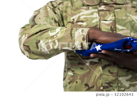Mid section of soldier holding an american flag 32102643