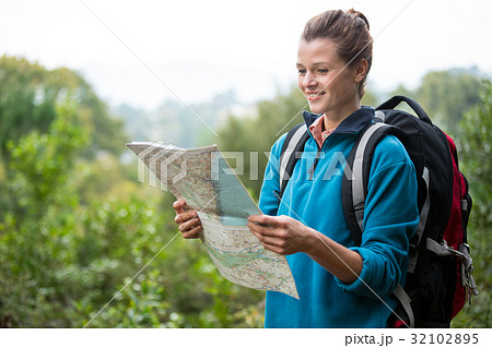 Female hiker looking at map 32102895