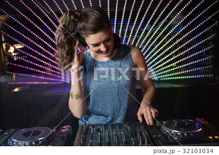 Pretty female DJ playing music 32103034