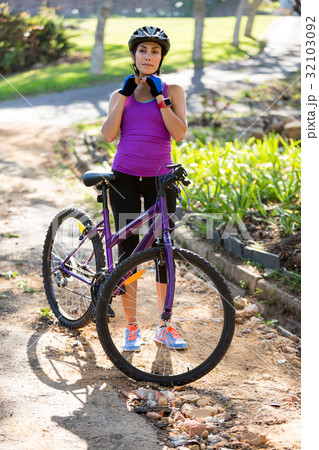 Female athletic wearing bicycle helmet 32103092