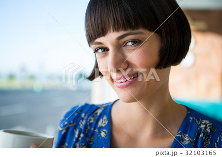 Smiling woman in a coffee shop Smiling woman in a coffee shop 32103165