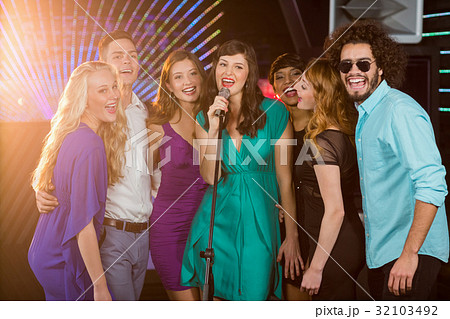Group of friends singing song together in bar Group of friends singing song together in bar 32103492
