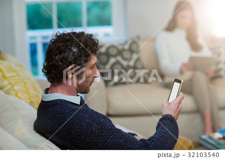 Man using mobile phone 32103540