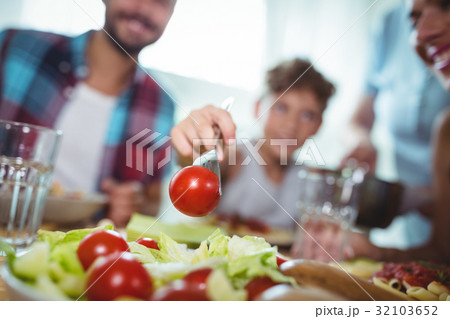 Smiling boy taking some salad 32103652