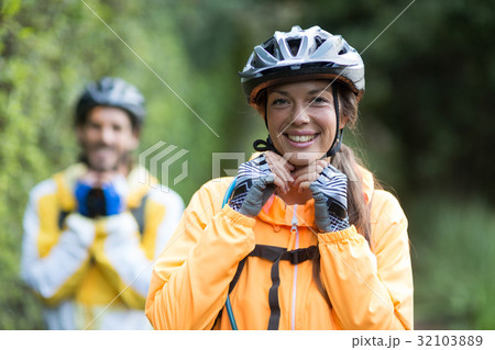 Female biker wearing bicycle helmet Female biker wearing bicycle helmet 32103889