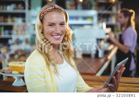 Portrait of smiling woman using digital tablet Portrait of smiling woman using digital tablet 32103891