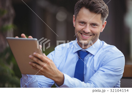 Portrait of businessman using digital tablet 32104154
