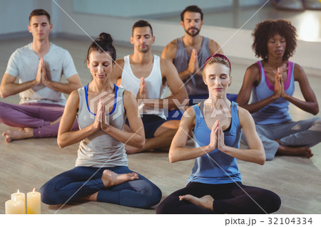 Group of people performing yoga 32104334