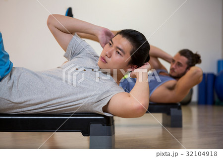 Two men doing aerobic exercise on stepper 32104918