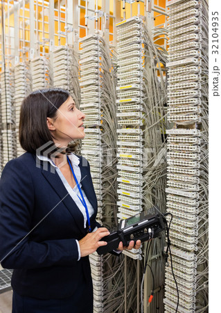 Technician using digital cable analyzer Technician using digital cable analyzer 32104935
