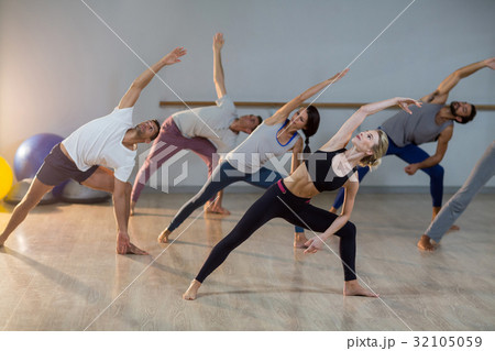 Group of people performing stretching exercise 32105059