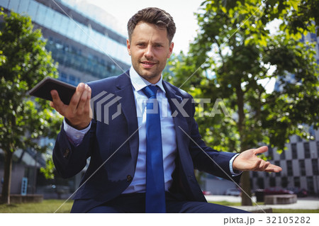 Portrait of handsome businessman holding mobile phone 32105282