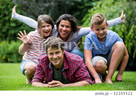 Happy family smiling in park Happy family smiling in park 32105522