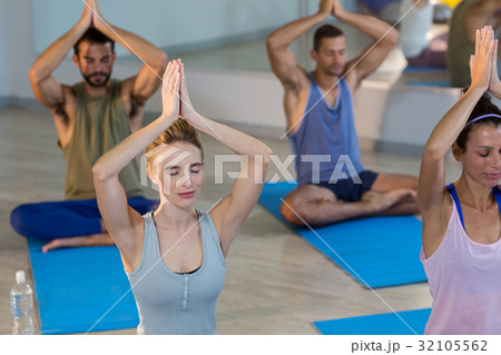 Group of people performing yoga Group of people performing yoga 32105562