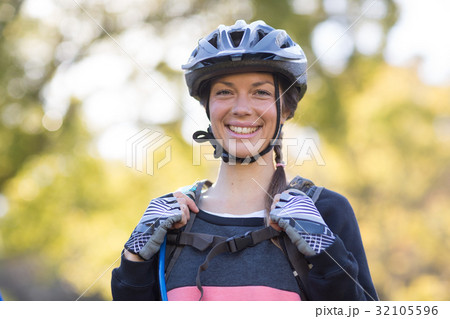 Female biker smiling with backpack 32105596