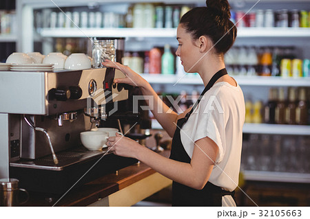 Smiling waitress making cup of coffee Smiling waitress making cup of coffee 32105663