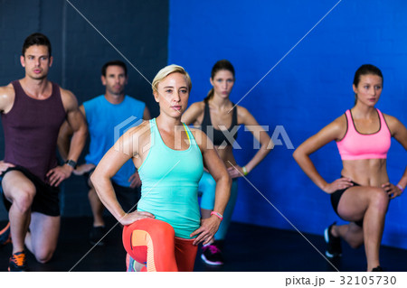 Determined athletes exercising in fitness studio 32105730