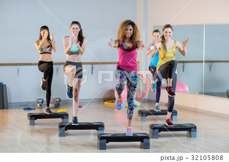 Group of women exercising on aerobic stepper Group of women exercising on aerobic stepper 32105808