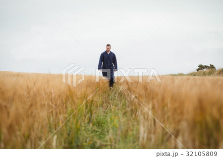 Farmer checking his crops Farmer checking his crops 32105809