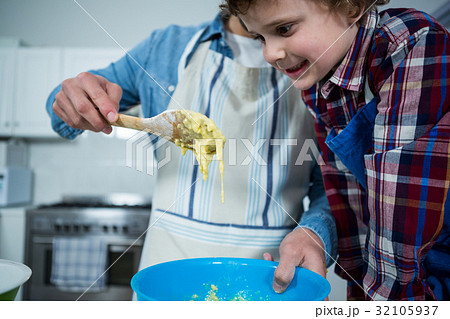 Father and son preparing cupcake Father and son preparing cupcake 32105937