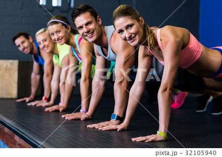 Male and female athletes doing push-ups Male and female athletes doing push-ups 32105940