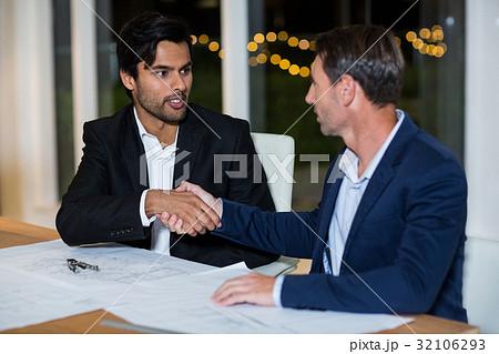 Businessmen shaking hands with each other Businessmen shaking hands with each other 32106293