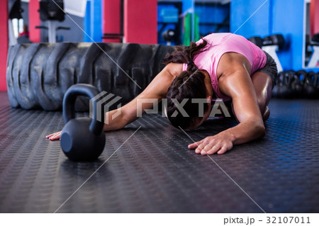 Female athlete exercising in gym Female athlete exercising in gym 32107011