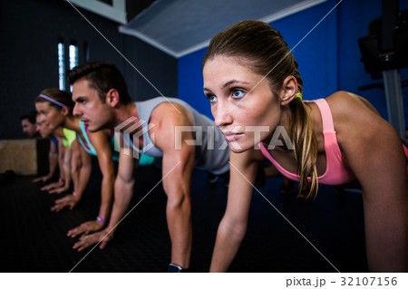 Athletes doing push-ups in gym 32107156