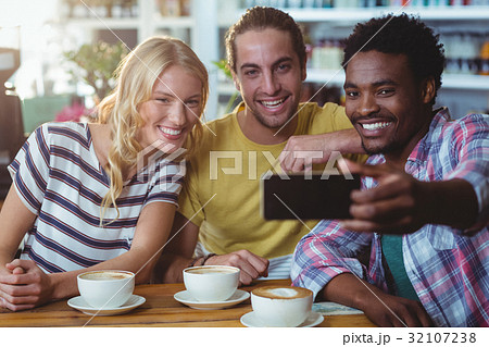 Three friends taking a selfie 32107238