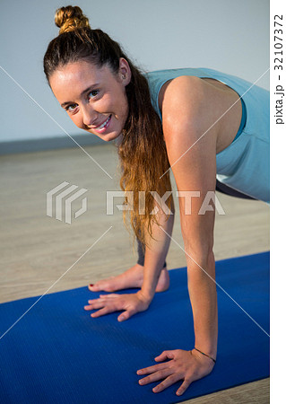Portrait of smiling woman performing yoga Portrait of smiling woman performing yoga 32107372
