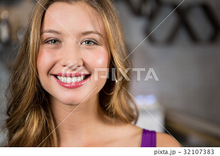 Smiling young woman in bar Smiling young woman in bar 32107383
