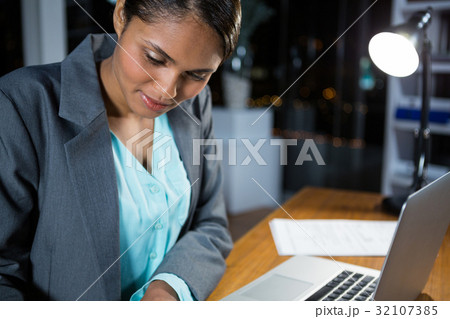 Businesswoman working on laptop Businesswoman working on laptop 32107385