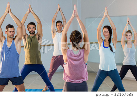 Instructor taking yoga class Instructor taking yoga class 32107638