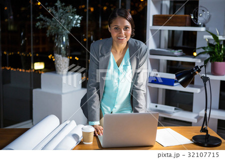 Businesswoman working on laptop 32107715