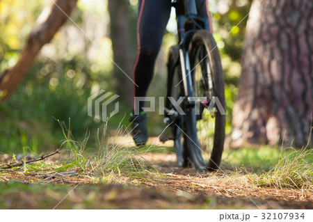 Low section of female mountain biker riding bicycle Low section of female mountain biker riding bicycle 32107934