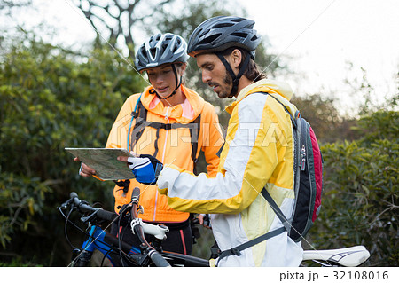 Biker couple looking at a map Biker couple looking at a map 32108016