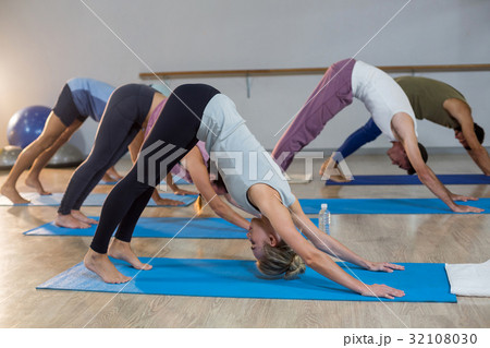 Group of people performing yoga 32108030