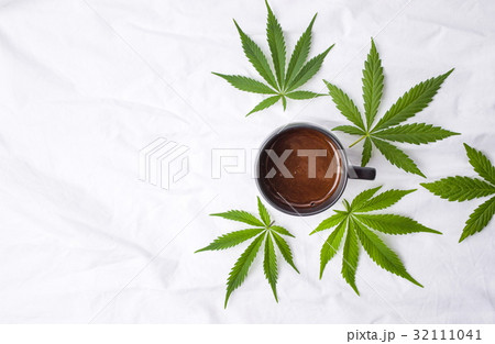 Marijuana leaves and a cup of coffee Marijuana leaves and a cup of coffee 32111041