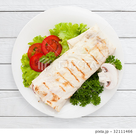 Shawarma. Sandwich wrap of pita bread on plate 32111466