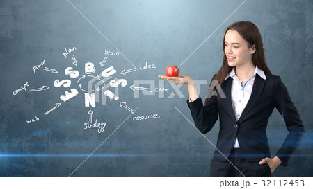 Beauty girl in a suit standing near wall with a 32112453