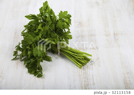 Fresh parsley on a light wooden background. Fresh parsley on a light wooden background. 32113158