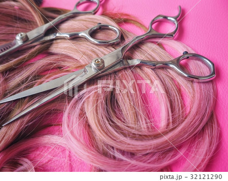 Hair cutting shears on pink background 32121290