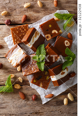 Caramel candy with nuts close-up on the table. Caramel candy with nuts close-up on the table. 32122438