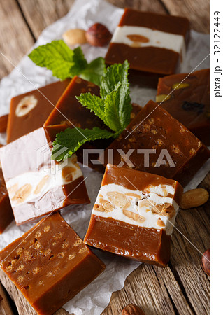 Delicious caramelized toffee with nuts close-up Delicious caramelized toffee with nuts close-up 32122449