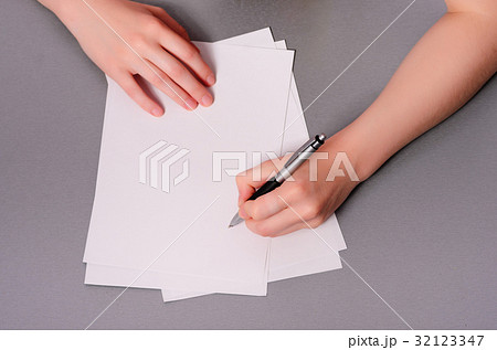 Human hands with pencil writing on paper Human hands with pencil writing on paper 32123347